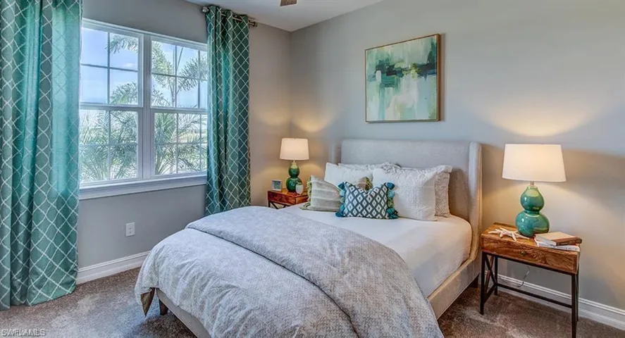Bedroom featuring carpet floors, multiple windows, and ceiling fan
