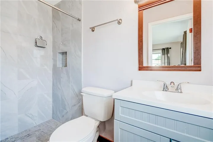 Full bathroom with vanity and a shower