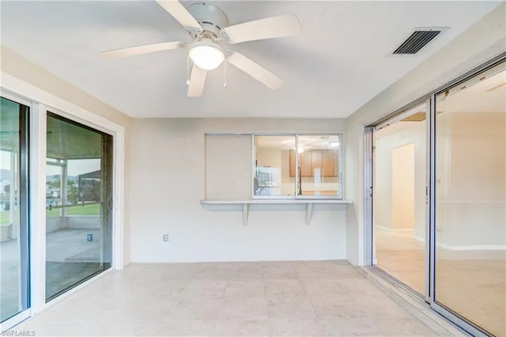 Unfurnished sunroom with ceiling fan