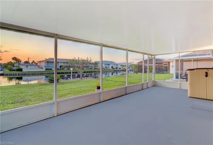 Unfurnished sunroom featuring a water view