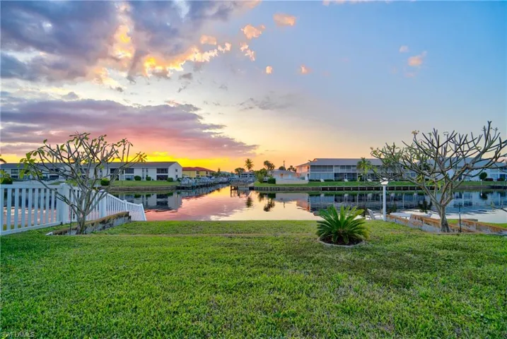 Yard at dusk featuring a water view