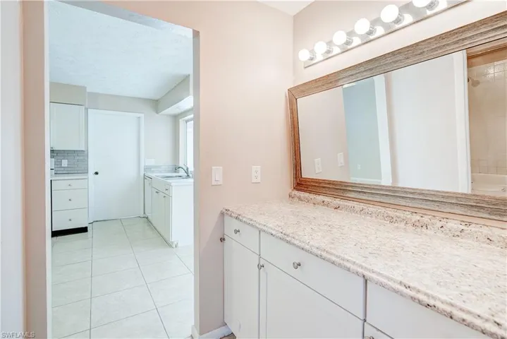 Bathroom featuring vanity, tile patterned floors, tasteful backsplash, a shower, and a bath
