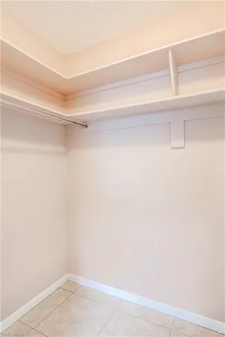 Walk in closet with light tile patterned flooring