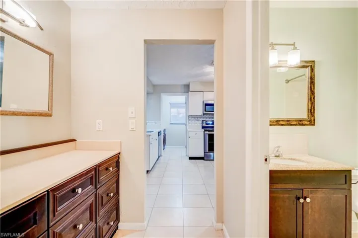 Bathroom featuring vanity, tasteful backsplash, and tile patterned flooring
