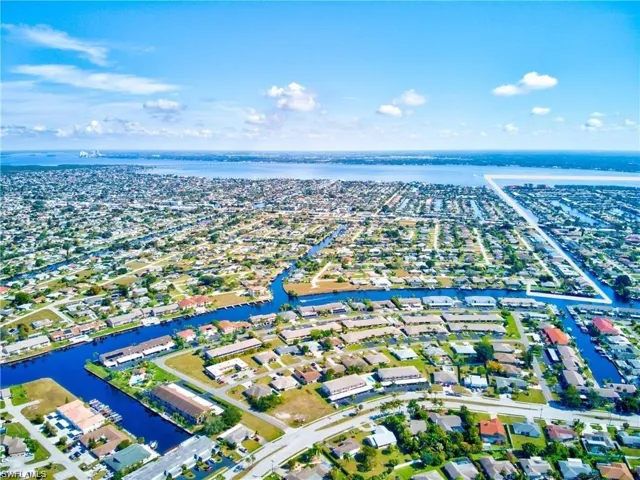 Birds eye view of property featuring a water view and a residential view