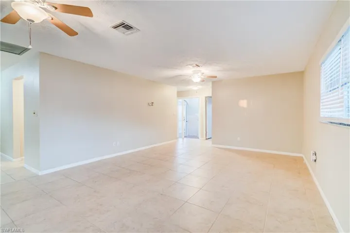 Unfurnished room with ceiling fan and a textured ceiling
