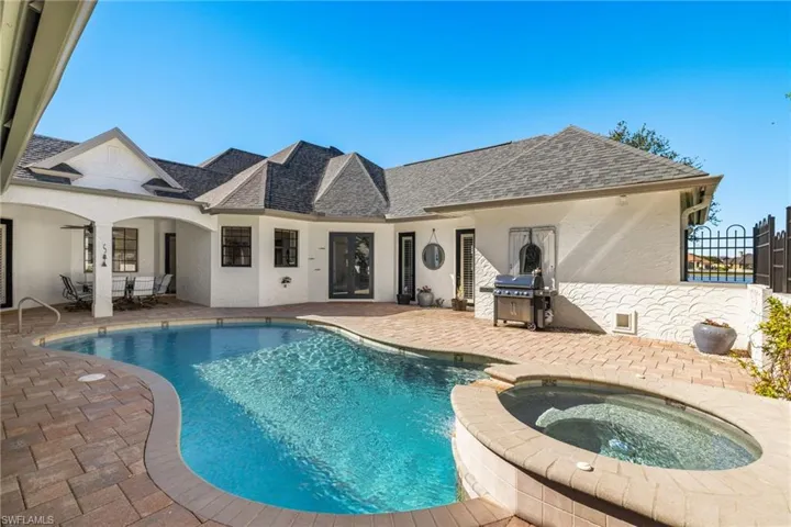 View of pool featuring an in ground hot tub, a patio, and a grill
