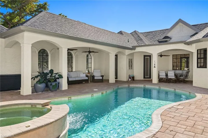 View of swimming pool featuring an in ground hot tub, ceiling fan, a patio, and an outdoor living space