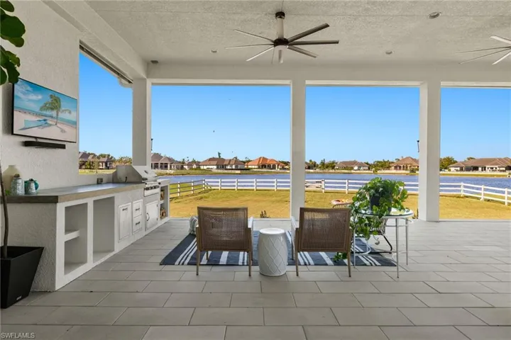 Large sliders from the dining room and living room lead to covered back patio with outdoor grill.