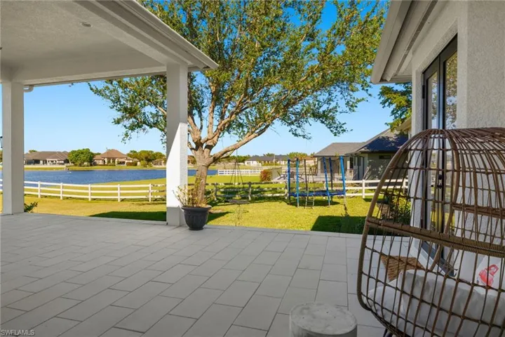 View of back patio / terrace featuring a water view