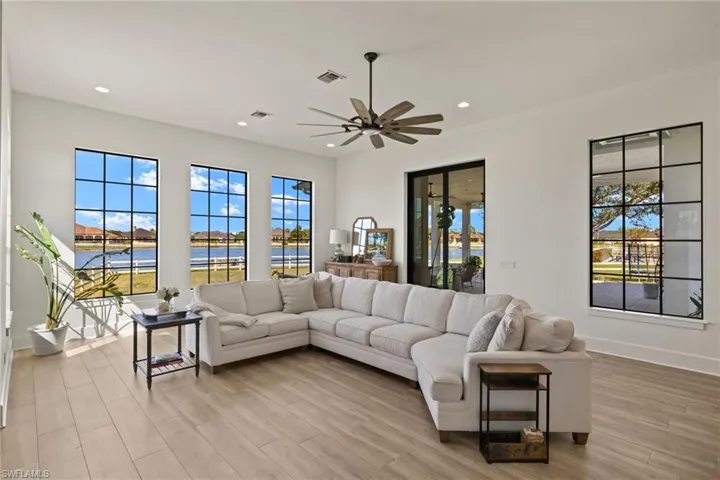 Living room featuring light hardwood / wood-style floors, a wealth of natural light, and ceiling fan