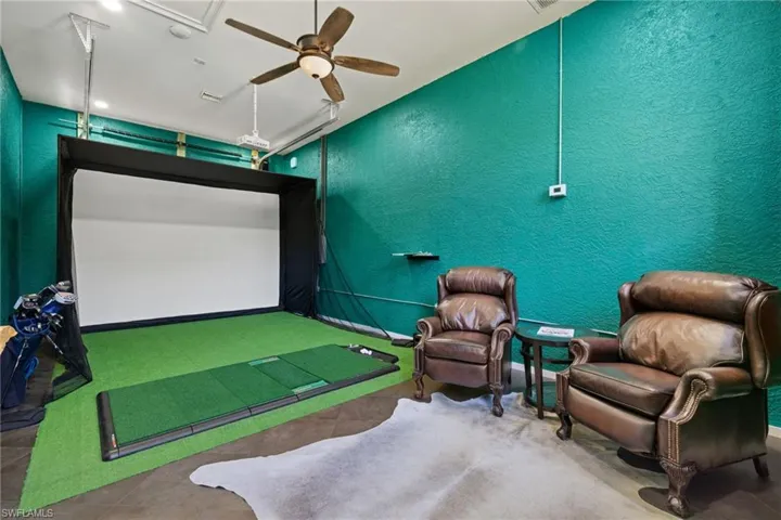 Man Cave garage under air with ceiling fan.