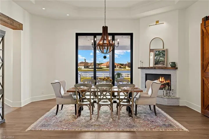Dining area featuring crown molding, dark hardwood / wood-style flooring, and a fireplace