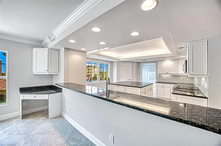Kitchen with breakfast bar and built-in desk area
