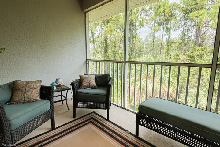 Sunroom / solarium featuring a balcony