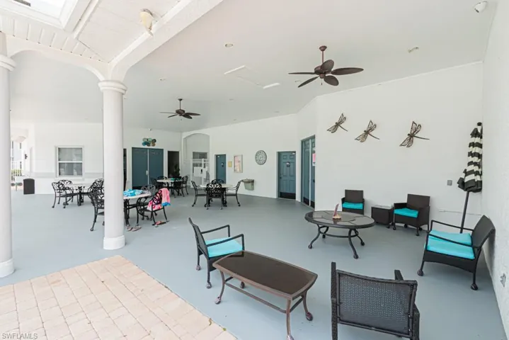 View of patio with ceiling fan and outdoor dining space