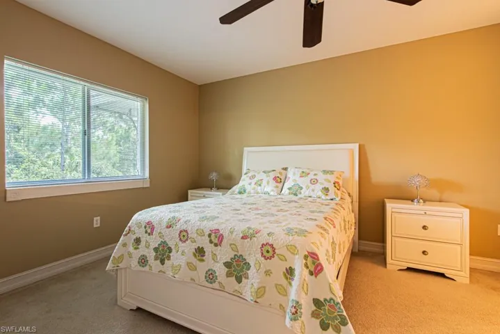 Bedroom featuring light colored carpet and a ceiling fan