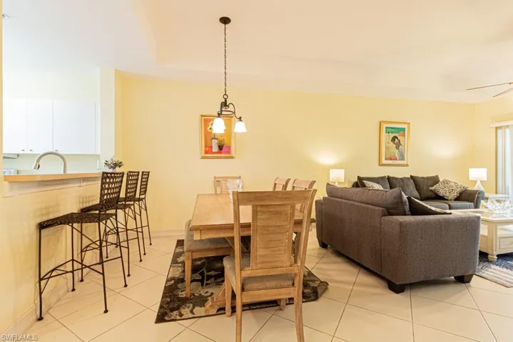 Dining room featuring light tile patterned flooring and baseboards