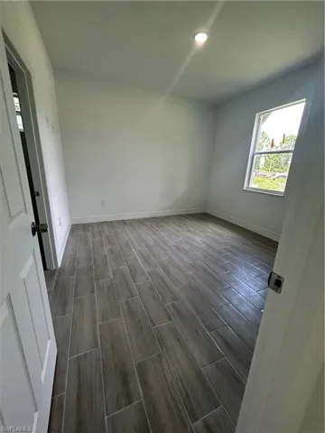 Spare room featuring wood finish floors and recessed lighting