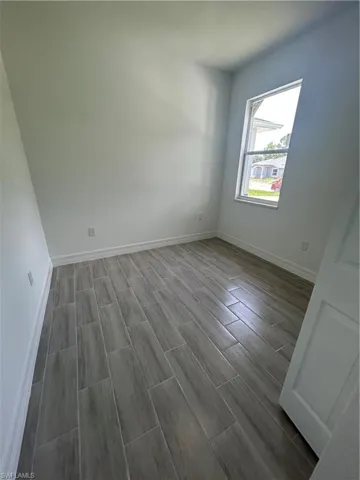 Unfurnished room featuring wood finish floors