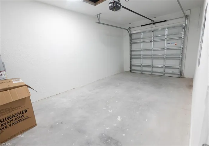 Garage with a garage door opener and a textured wall
