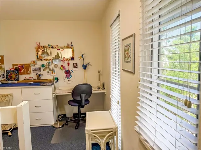 Bedroom featuring carpet flooring and baseboards