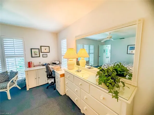 Office featuring ceiling fan and dark carpet