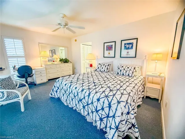 Full bathroom with a closet, vanity, tile patterned flooring, and a tray ceiling