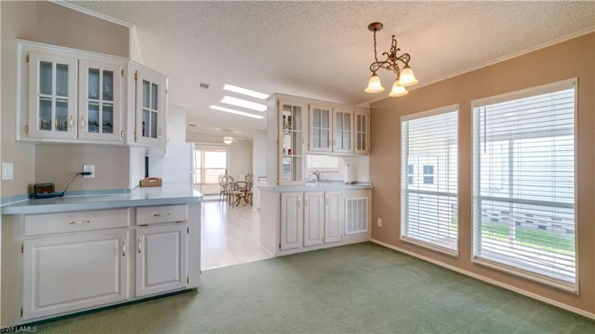 Built-in cabinetry continues into the dining area. Lovely windows provide Southwest Florida sunshine.