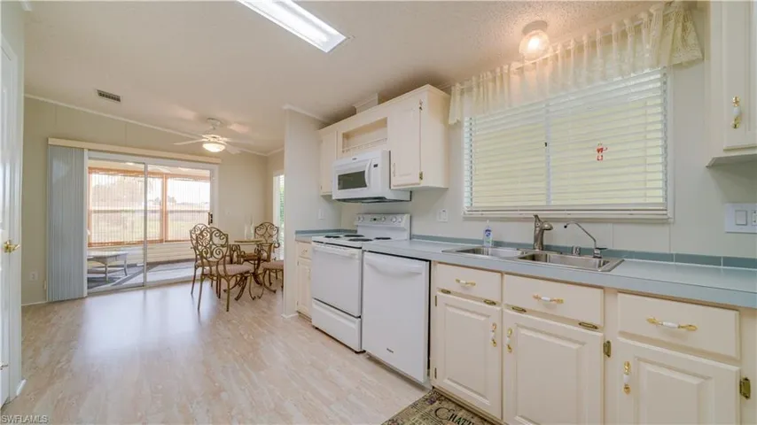 An oversized, meticulously maintained kitchen featuring a double kitchen window.