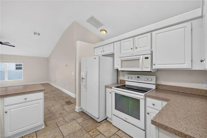 Kitchen with rear living room beyond