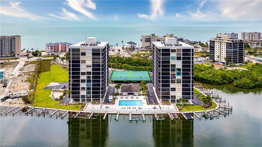 Birds eye view of property with a water view