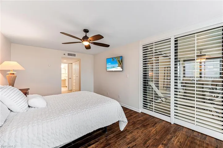 Bedroom with dark wood-type flooring and ceiling fan