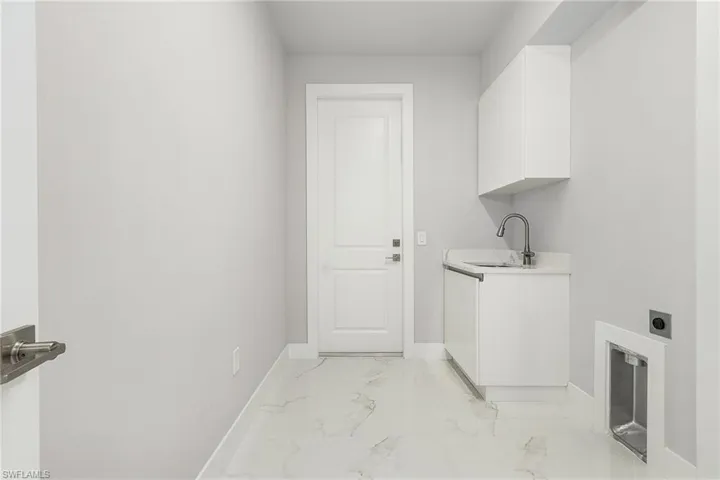 with vanity, cabinets, and closet