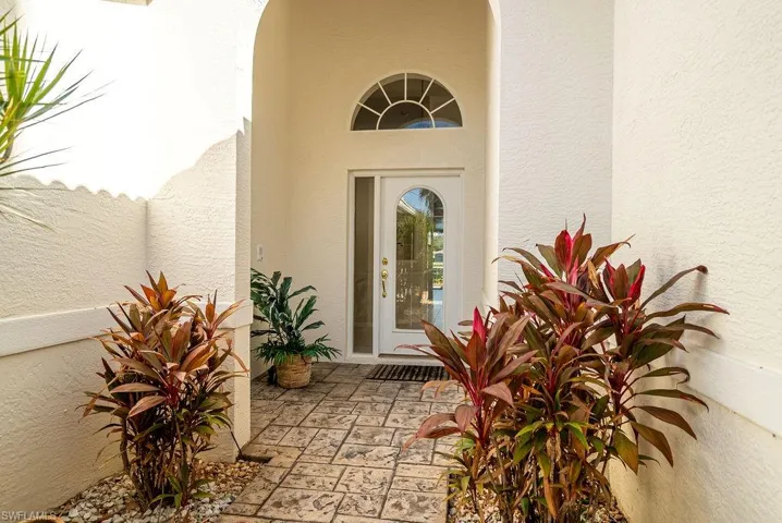 Property entrance featuring stucco siding