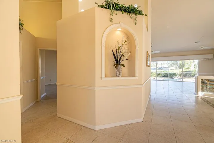 Hall with light tile patterned floors and baseboards