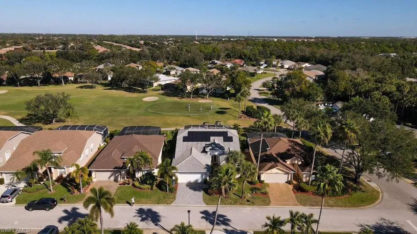 Aerial view of residential area with a golf club