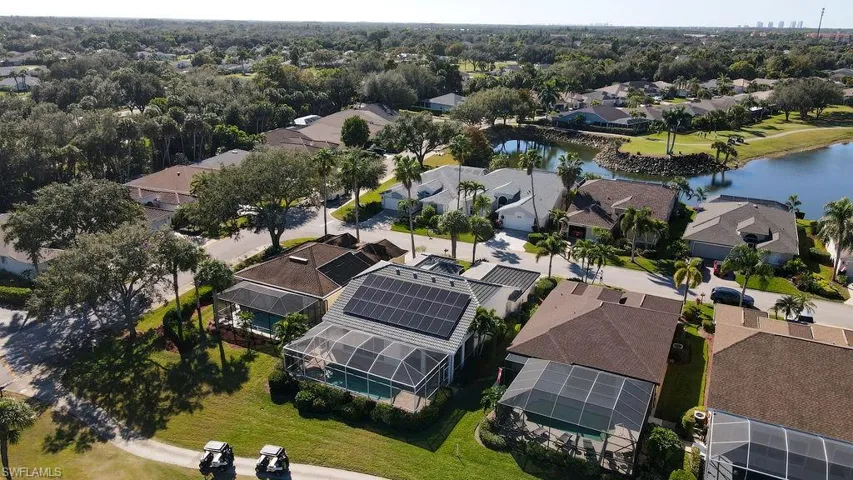 Aerial view of residential area featuring a nearby body of water