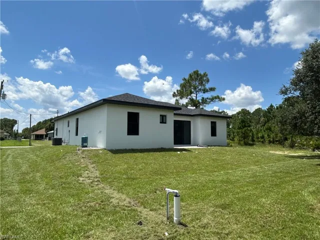 Rear view of property featuring a lawn