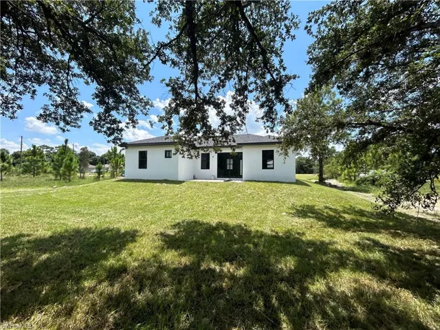 Rear view of property with a lawn