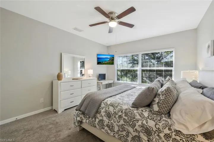 Bedroom featuring ceiling fan and light colored carpet