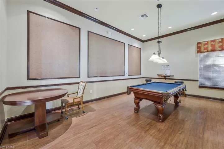 Rec room with billiards, light hardwood / wood-style flooring, and ornamental molding