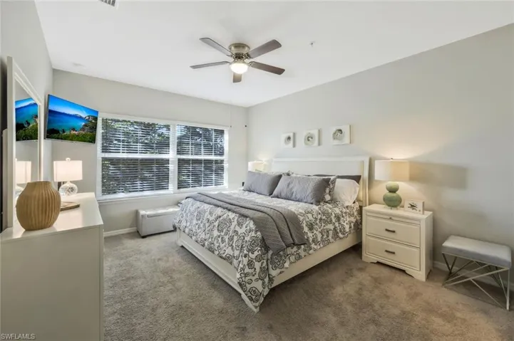 Carpeted bedroom with ceiling fan