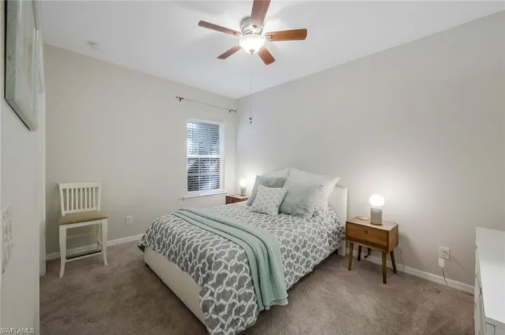 Bedroom featuring ceiling fan and carpet