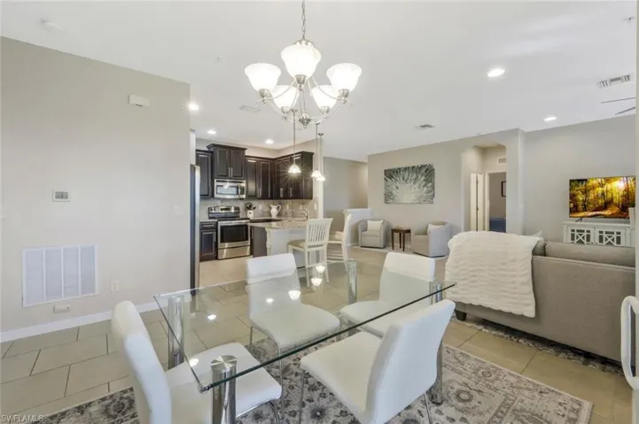 Tiled dining room featuring a chandelier