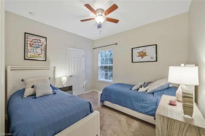 Carpeted bedroom with ceiling fan