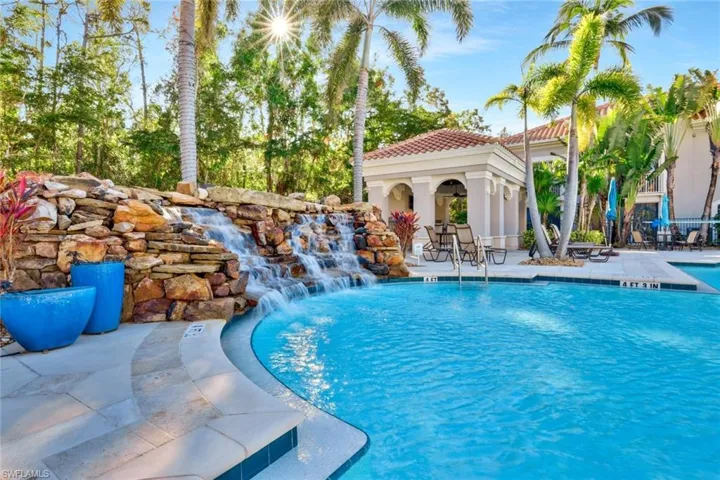 View of swimming pool with a patio area and pool water feature