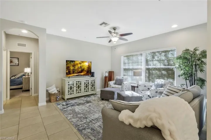 Living room featuring ceiling fan and light tile patterned floors