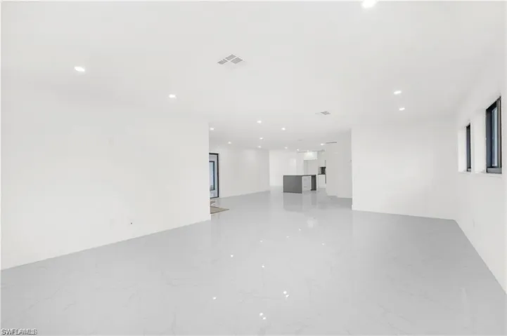 Empty room featuring recessed lighting and light marble finish flooring