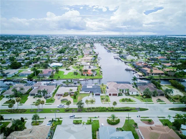 Aerial perspective of suburban area featuring a large body of water